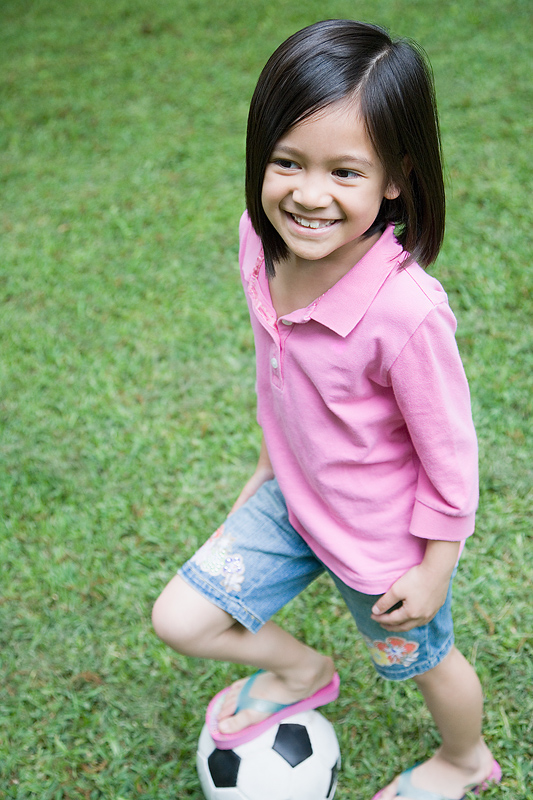 Photo of a young girl playing soccer